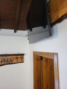 a television hanging on a wall next to a door at Moinho da Quinta da Esperança in Ourém