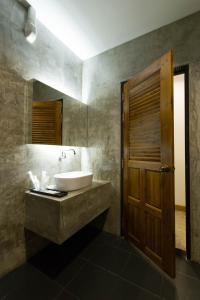 a bathroom with a sink and a mirror at Pagoda Sight Residence in Nan