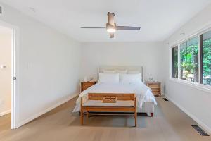 a white bedroom with a bed and a ceiling fan at Modern 3BR With Big Kitchen & TV Rm in State College