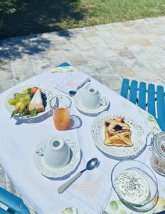 a table with plates of food and drinks on it at Audaces Resort in Recanati