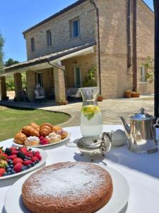 a table with two plates of food on it at Audaces Resort in Recanati
