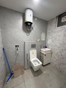 a bathroom with a toilet and a sink at The Green Hush in Rājpur +18 photos