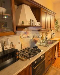 a kitchen with a stove and a stove top oven at Casettafiore in Civitavecchia +12 photos