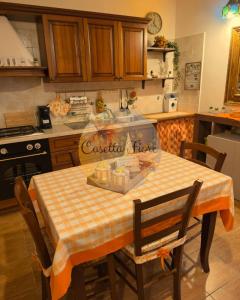 a kitchen with a table with a checkered table cloth at Casettafiore in Civitavecchia