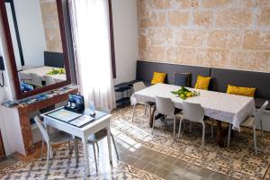 a dining room with a table and chairs and a mirror at "unic, turisme d'interior" in Andratx