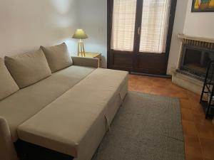 a couch in a living room with a fireplace at Casa Valero in Rubielos de Mora
