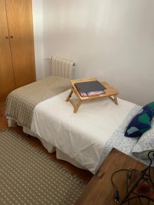 a room with two beds with a table on top of them at Casa Valero in Rubielos de Mora