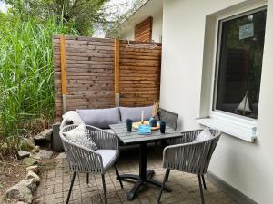 a patio with a table and chairs and a couch at Bungalow Blue Sky in Benz
