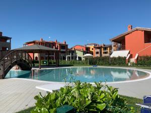 a swimming pool with a bridge and some buildings at Appartamento Corina in Sirmione