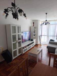 a living room with a couch and a tv at Ciudad De Sada in Sada +12 photos