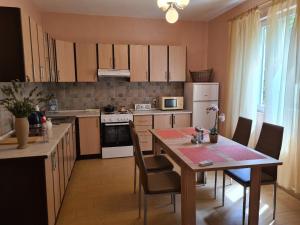 a kitchen with a table and a dining room at Zeta River Retreat in Danilovgrad