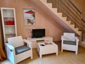 a living room with two chairs and a tv at Zeta River Retreat in Danilovgrad