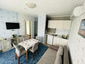 a kitchen and dining room with a table and chairs at Karolin Apartman in Bükfürdő