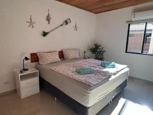 a bedroom with a large bed in a room at Casa Alborada Bella Vista Itapúa in Bella Vista