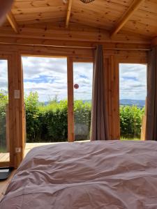 a bedroom with a bed in front of a window at Cedre bleu in Saint-Racho