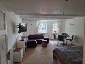 a living room with a couch and a table at FeWo Bismarck in Goslar