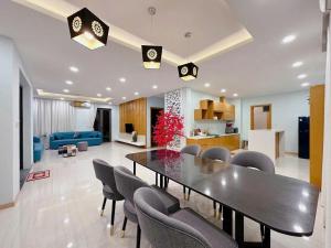 a dining room and living room with a table and chairs at MT Luxury Villas Phu Quoc in Phú Quốc