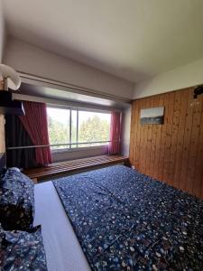a bedroom with a bed and a large window at Casa Cris SoleAlto in Marilleva