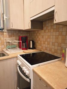 a kitchen with a stove top oven in a kitchen at il tesorino di Corfu in Corfu