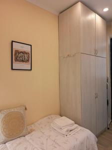 a bedroom with a bed and a cabinet at il tesorino di Corfu in Corfu +1 photo