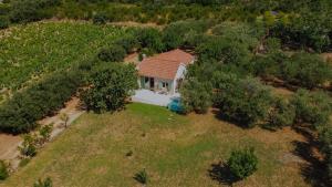 an overhead view of a house in a field with trees at Captain`s Cottage in Kaštela