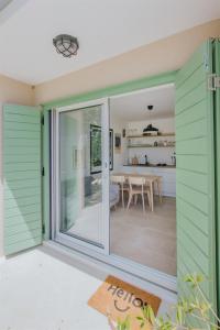 a sliding glass door leading to a dining room and kitchen at Captain`s Cottage in Kaštela +40 photos