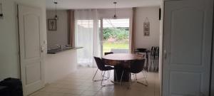 a kitchen with a table and chairs in a room at Maison au calme in La Roche-sur-Yon