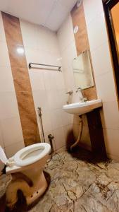 a dirty bathroom with a toilet and a sink at Hotel Crystal Inn in Lucknow