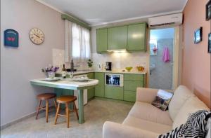 a kitchen with a couch and a table in a room at Alessandro's Apartment in Mantoúkion