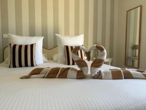 a stuffed animal is laying on a bed at CÉRÈS - Boutique-Hôtel & Spa - Élégance en Terre d'Uzès in Saint-Quentin-la-Poterie