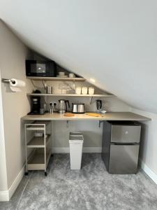 an attic kitchen with a desk in a room at Coastal Skylight Studio in Bettystown +30 photos