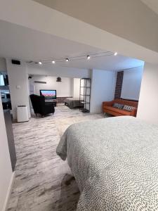 a bedroom with a bed and a living room at Blue rooms in Bilbao