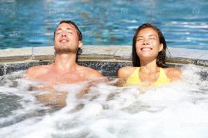 a man and a woman in a hot tub at Puruha Inn in Riobamba