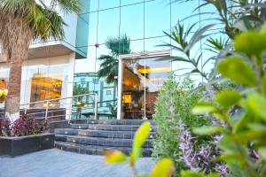 a glass building with stairs in front of it at تارا للشقق المخدومة in Riyadh