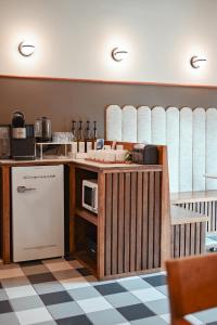 a kitchen with a counter with a microwave and a refrigerator at The Mansard House in Galveston