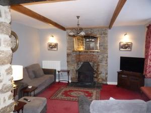a living room with a couch and a fireplace at The Old Seven Stars in Okehampton