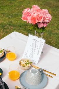 a table with a vase of flowers and a plate of food at Maison Pistache in Le Dorat +23 photos
