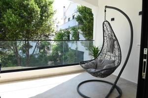 a hanging swing in a room with a window at Prima Garden Residence in Durrës