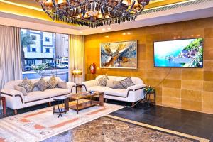 a living room with two couches and a tv at تارا للشقق المخدومة in Riyadh