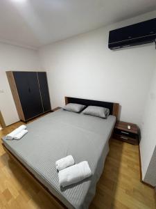 a bedroom with a large bed with two towels on it at DrimResidence in Struga