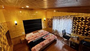 a bedroom with a large bed and a window at Star Palace in Pahalgām
