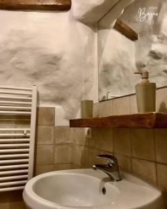a bathroom with a sink and a mirror at Trullo Galileo in Alberobello +34 photos