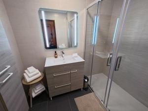 a bathroom with a sink and a shower with a mirror at Comfort Rooms Near Lisbon Airport - Carlotta Living in Lisbon