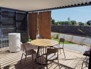 a patio with a table and chairs on a deck at Cottage haut de gamme, tout confort in Agde
