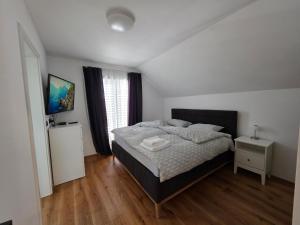 a bedroom with a bed and a television in it at Private House with Jacuzzi and Sauna in Domžale