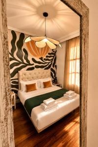 a bedroom with a large bed with a large mirror at Callao Suites in Madrid