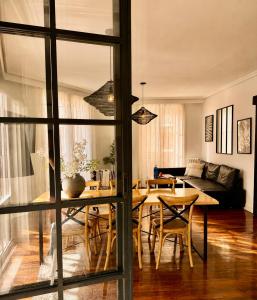 a living room with a table and a couch at Callao Suites in Madrid