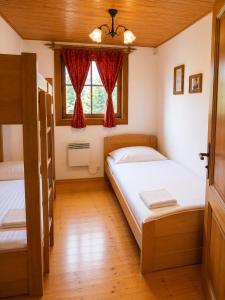 a bedroom with two beds and a window at Drevenica Podkovička - Terchová in Terchová