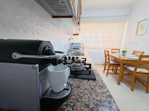 a kitchen counter with a coffee pot on a stove at Comfort Rooms Near Lisbon Airport - Carlotta Living in Lisbon +27 photos