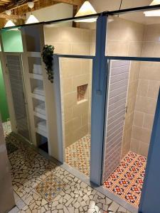a shower with a glass door in a bathroom at La Casa Rosada Hostel in Jericó +15 photos